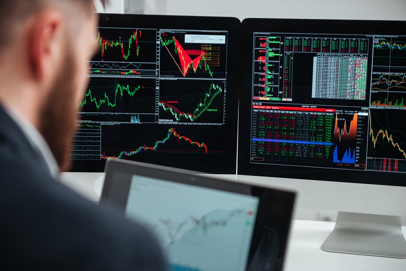 Monitors of computers with charts and graphs used by businessman
