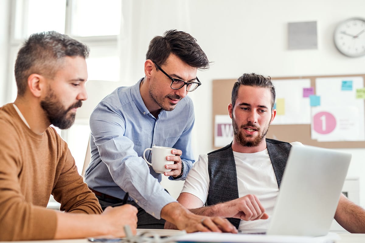 group of young businessmen with laptop working in FUBAM8V